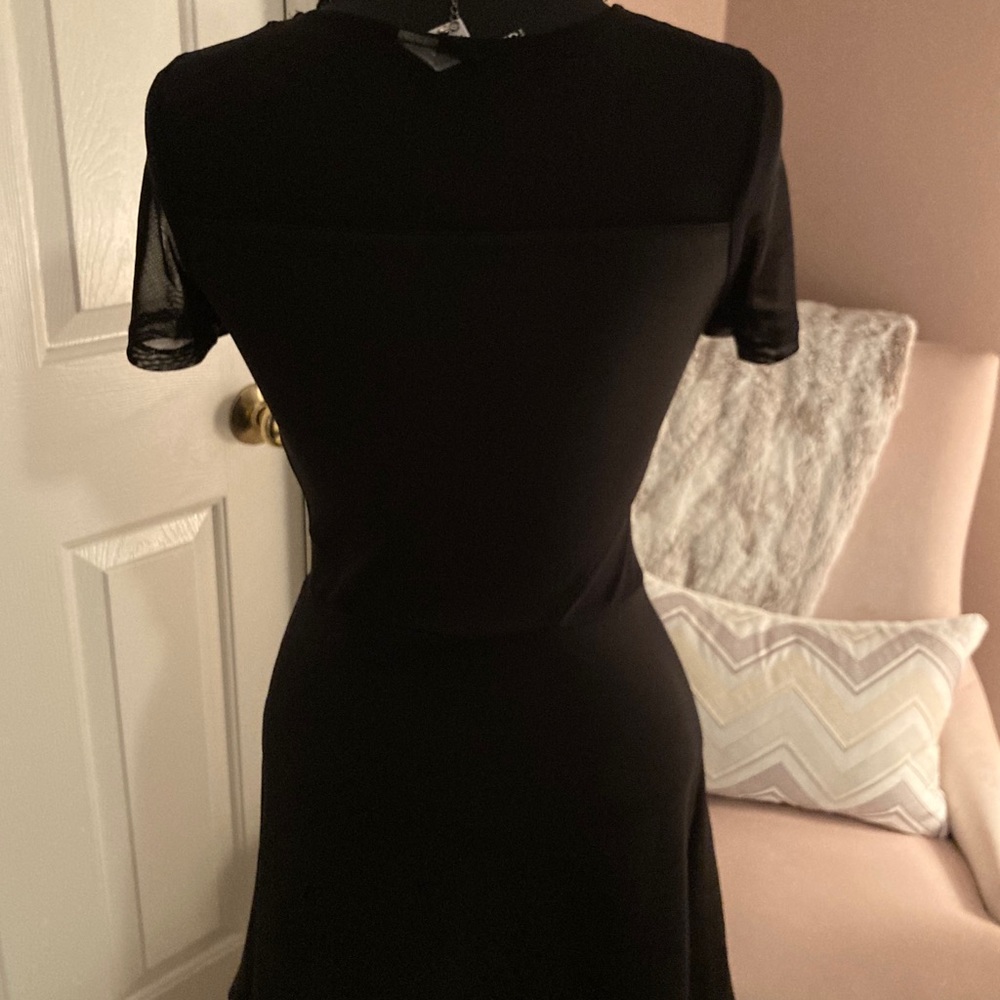 Black cocktail pull on dress with sheer detail
